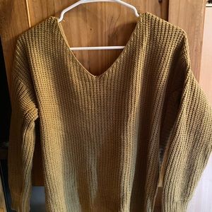 Fun Fall Sweater. V- neck front, Open in the back. Brown in color. Size small.